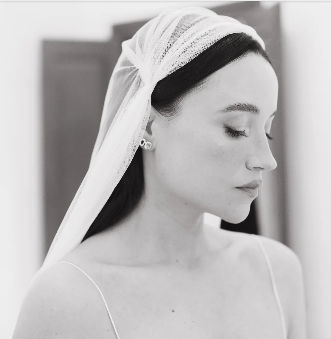 Marina wearing custom earrings by Aguamarga Studio on her wedding day in Barcelona.