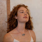 Grape silver and blown glass necklace worn by a model, handmade by Aguamarga Studio and House of VV in Barcelona