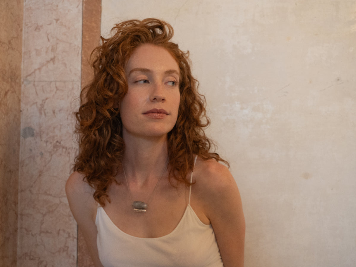 Grape silver and blown glass necklace worn by a model, handcrafted by Aguamarga Studio and House of VV in Barcelona